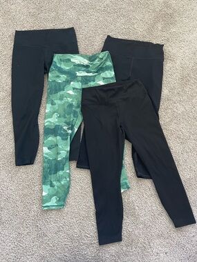 BUNDLE OF FOUR Fabletics PowerHold Leggings in (3) Black (1) green camo.